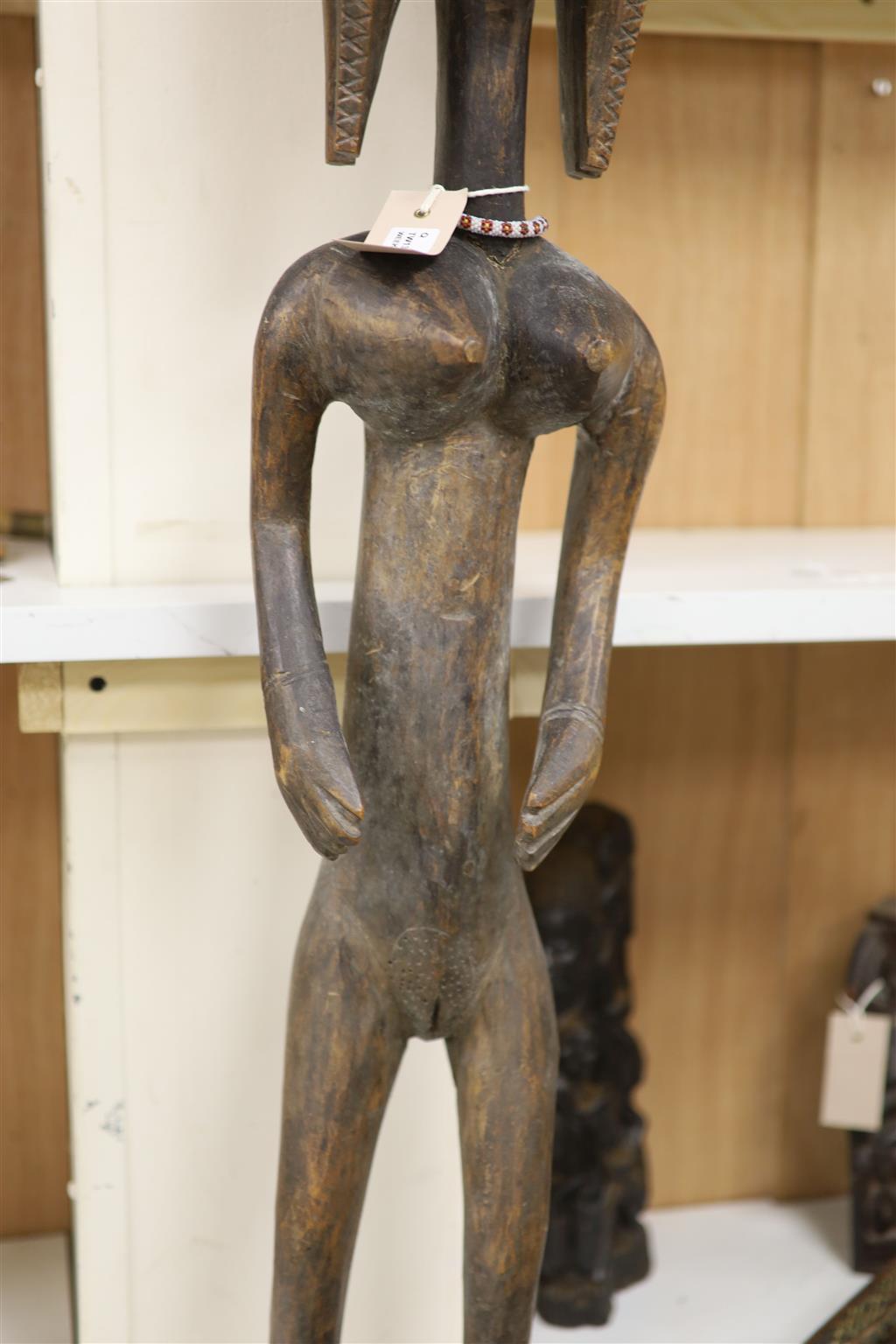 Ethnographia, a collection of various wood carvings, including an African tall female fertility figure,